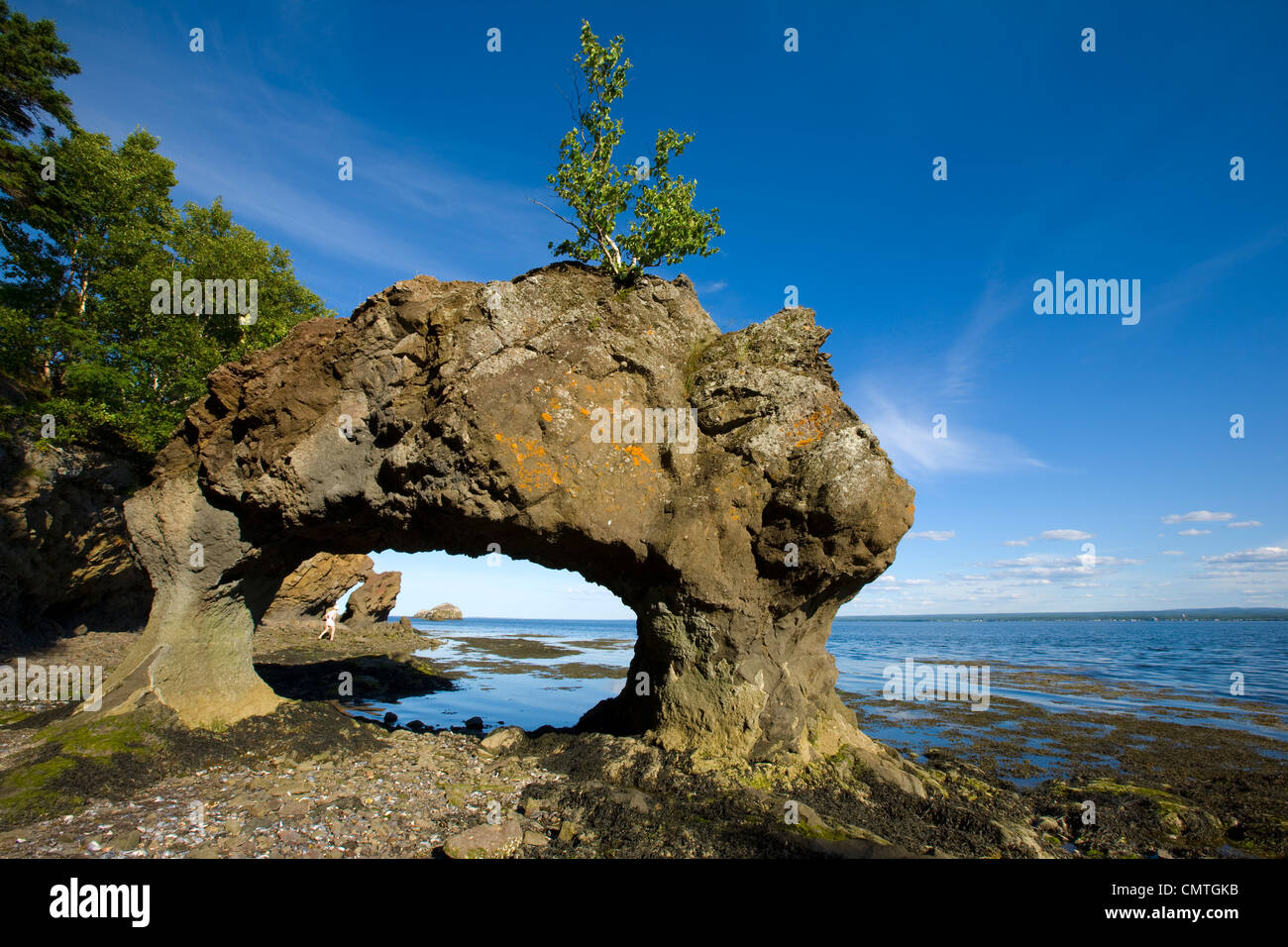 Woman walking through Bon Ami Rocks, Dalhousie, New Brunswick Stock