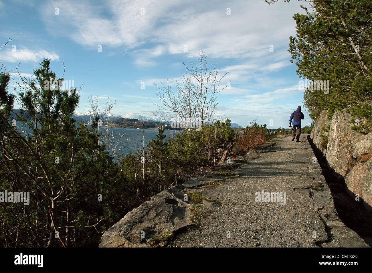 hiking footpath with view to high mountains and ocean in Klubba, Kristiansund, Norway Stock Photo