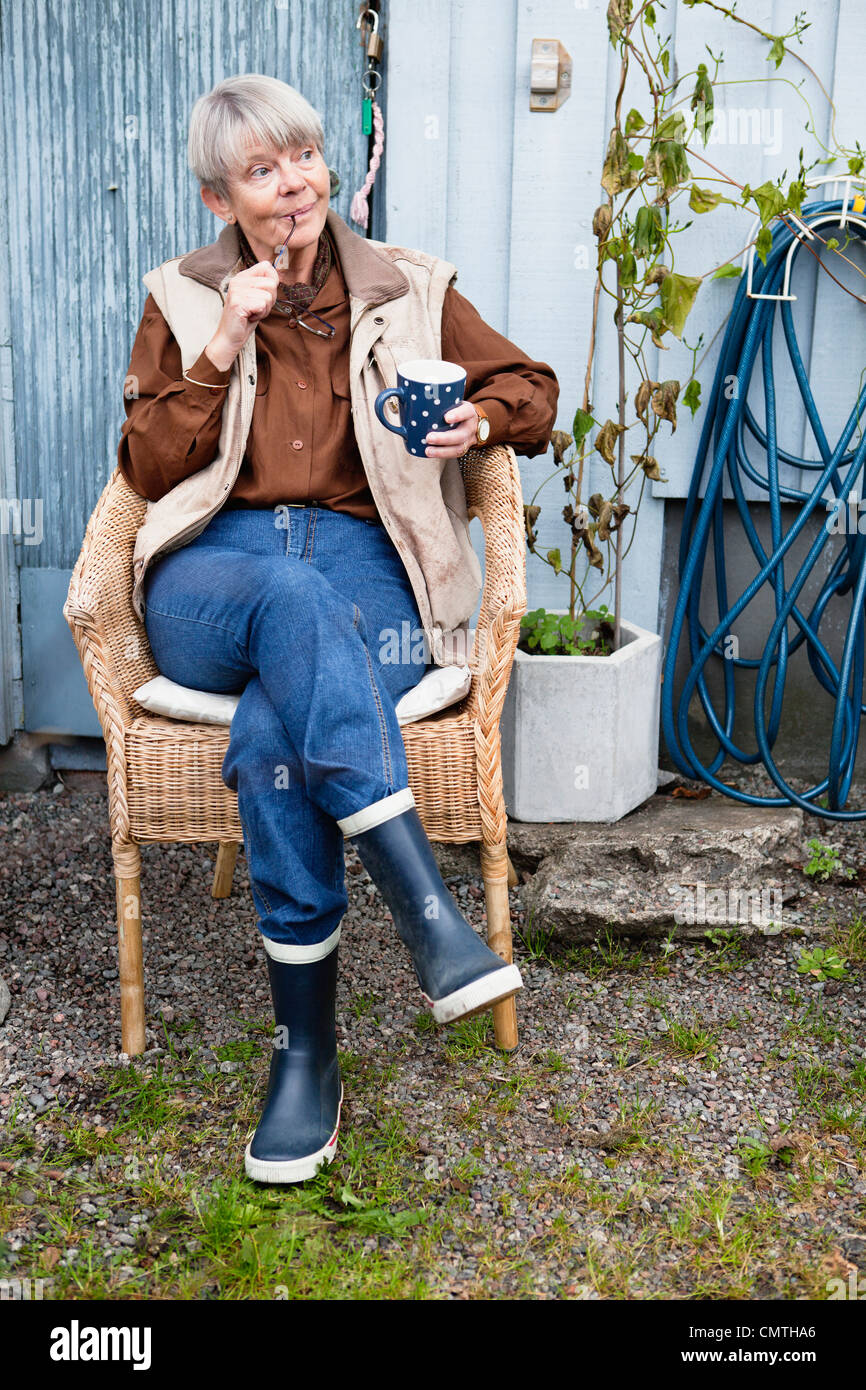 Person sitting on a chair hi-res stock photography and images - Alamy