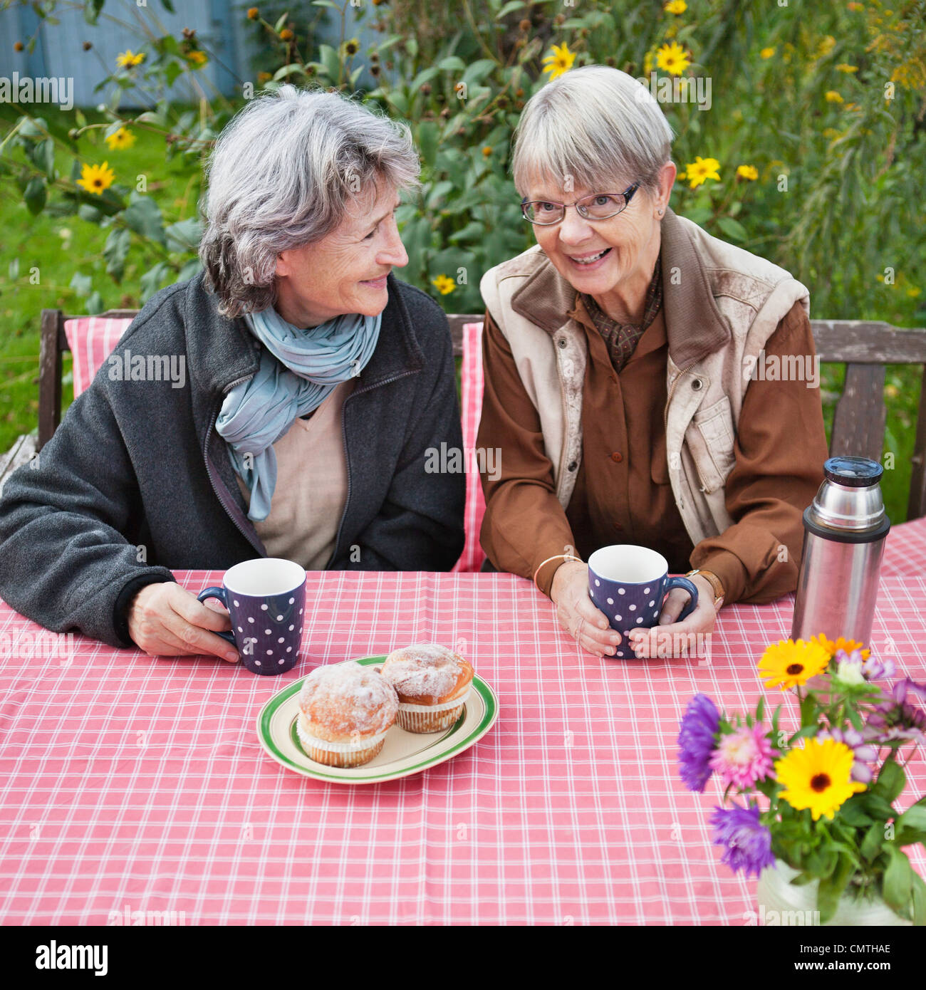 Two senior women drinks coffee at table Stock Photo Alamy
