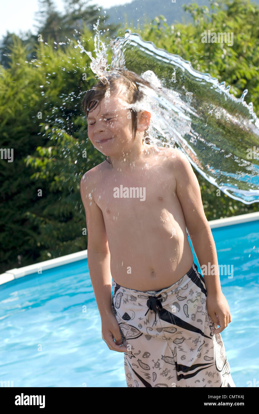 Young boy being splashed with water, Victoria, British Columbia Stock Photo