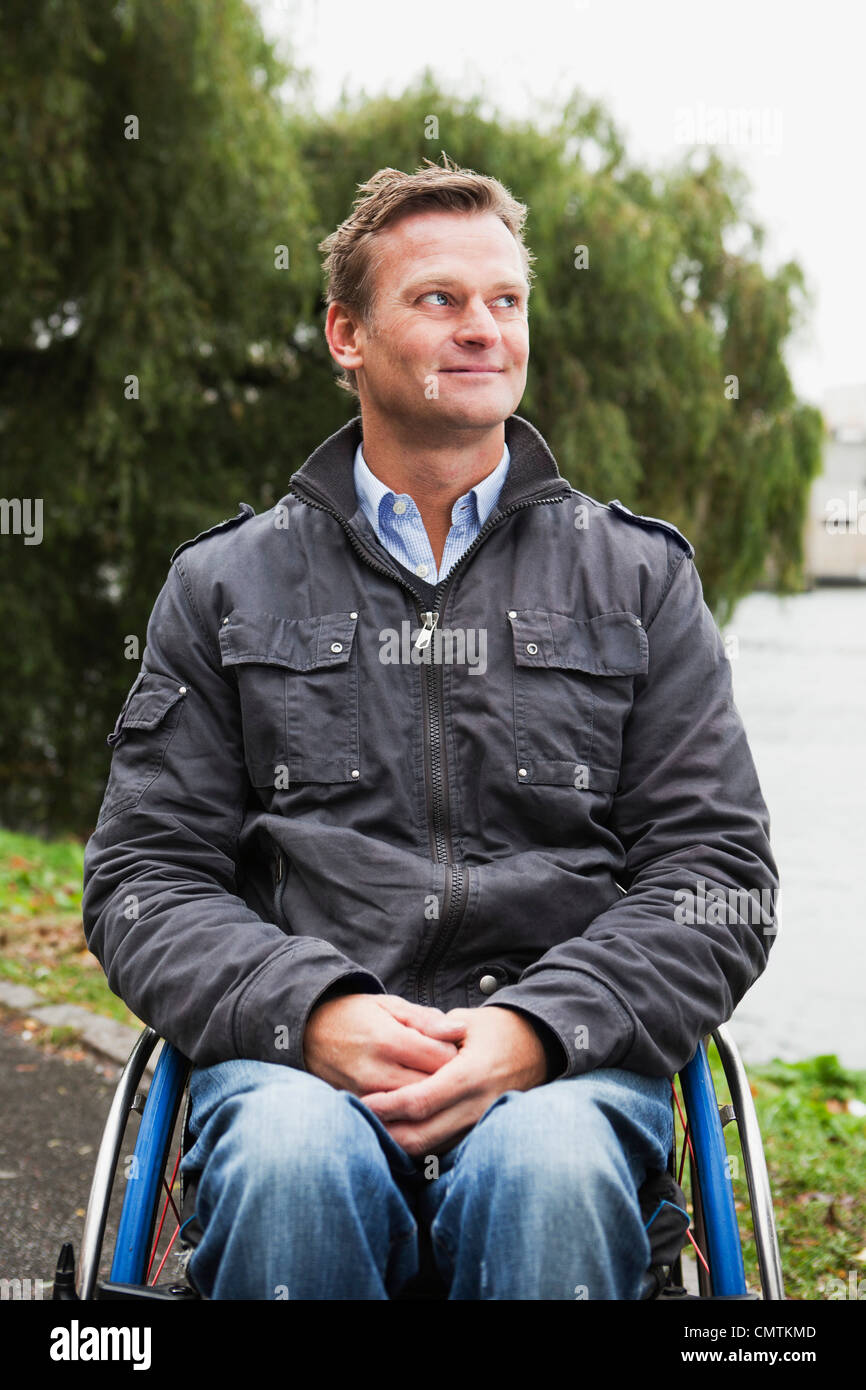 Man in wheelchair looking phone hi-res stock photography and images - Alamy