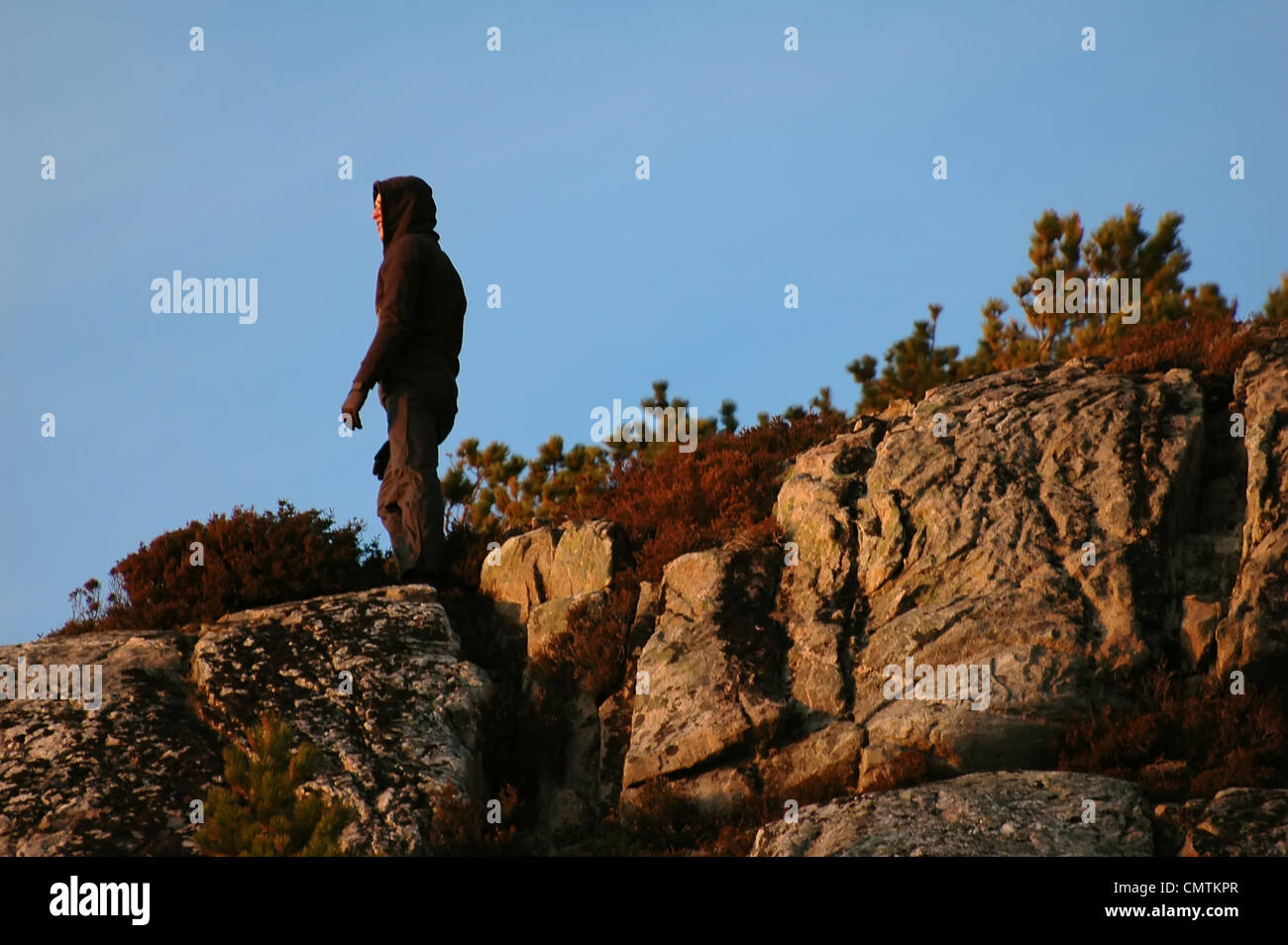 Silhouette man in hood standing hi-res stock photography and images - Alamy