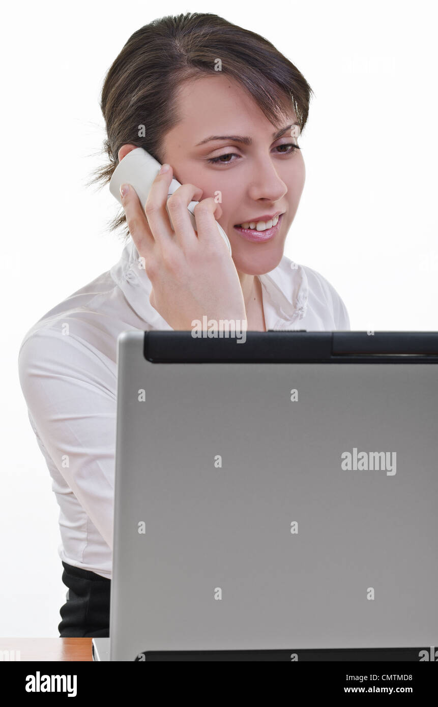 A portrait of office assistant looking at laptop screen and answering