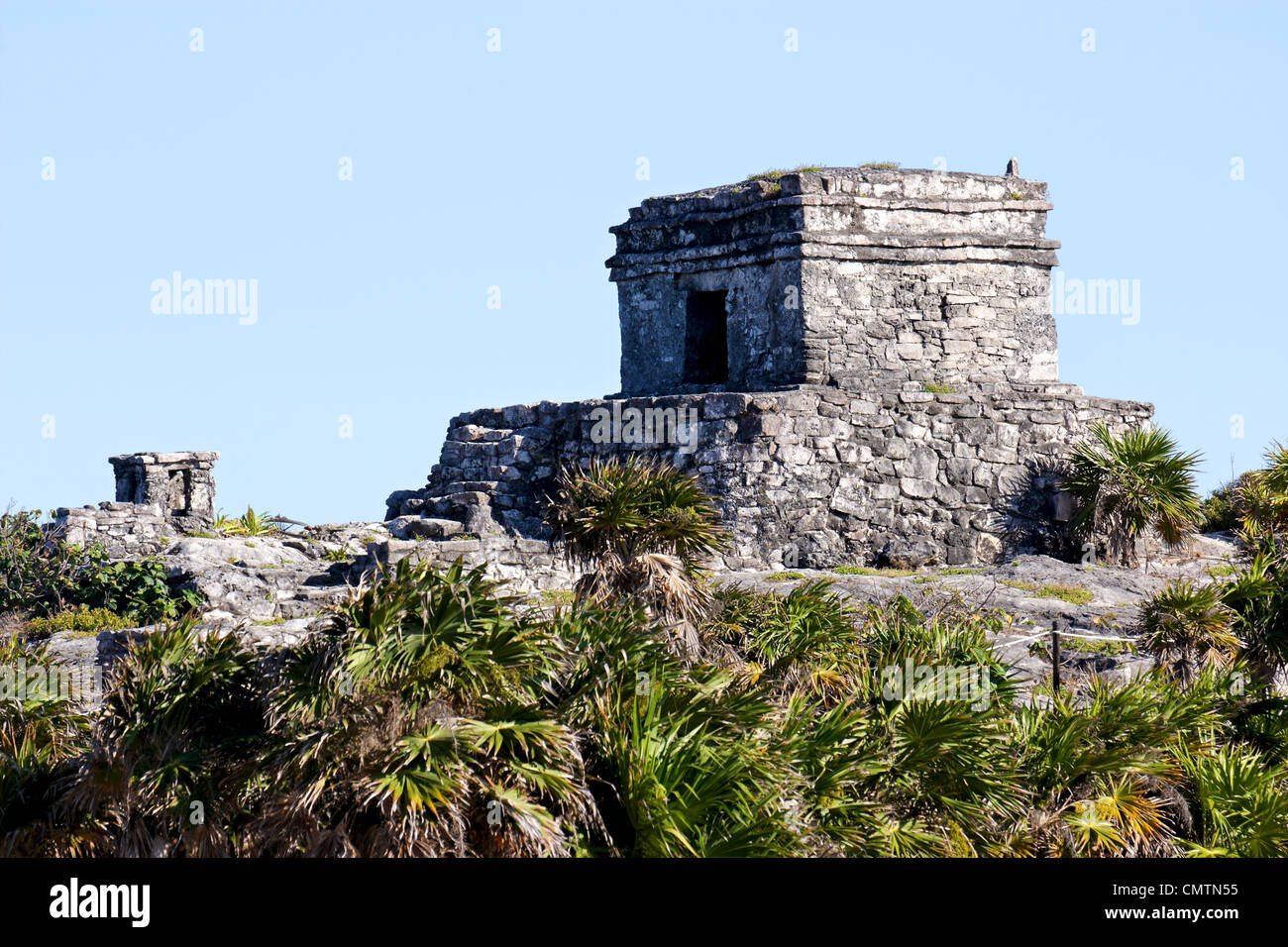 Mayan ruins in the sun before a clear blue sky at Tulum, Quintana Roo, Mexico. Stock Photo