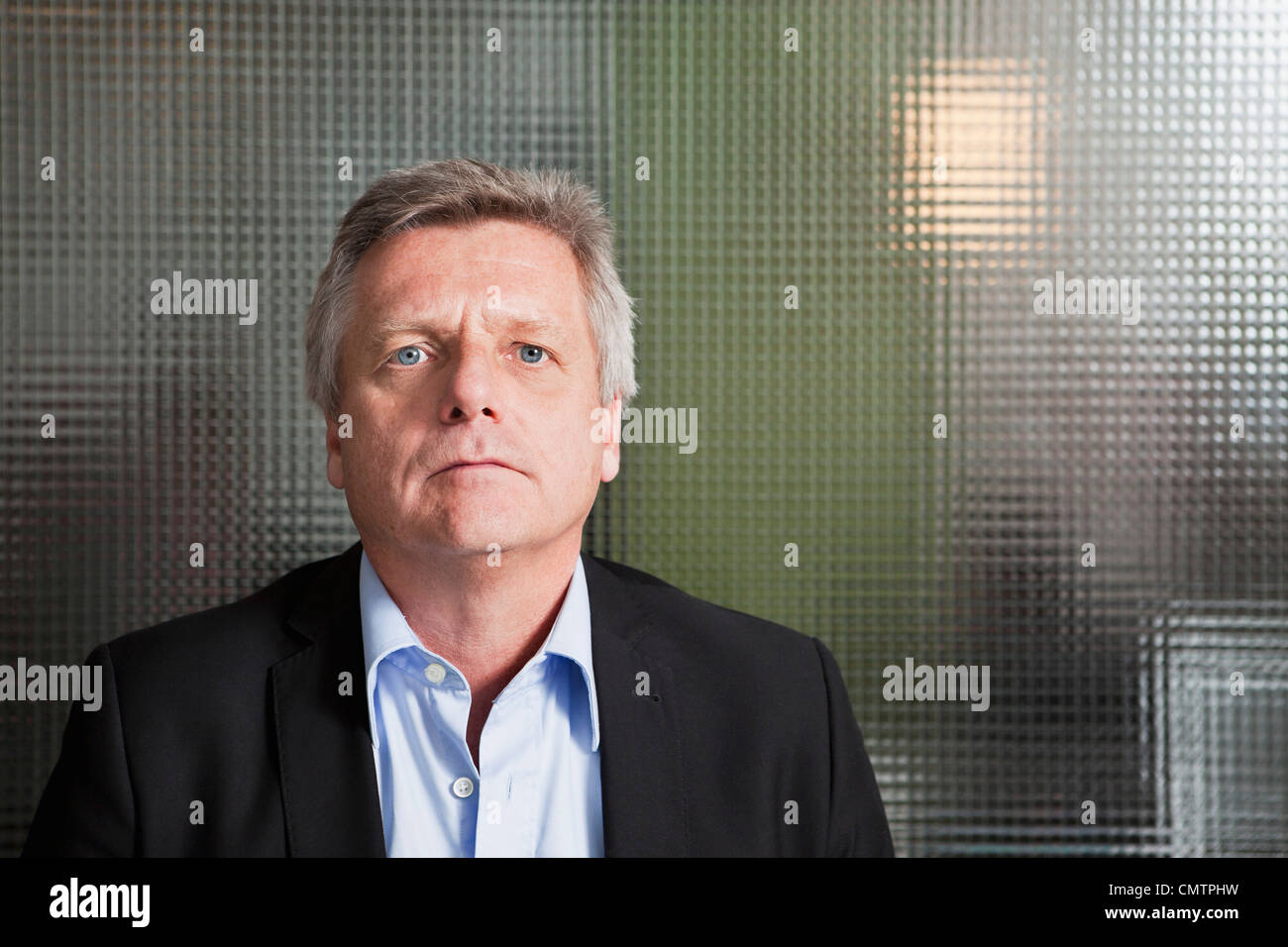 Man in front of transparent wall Stock Photo