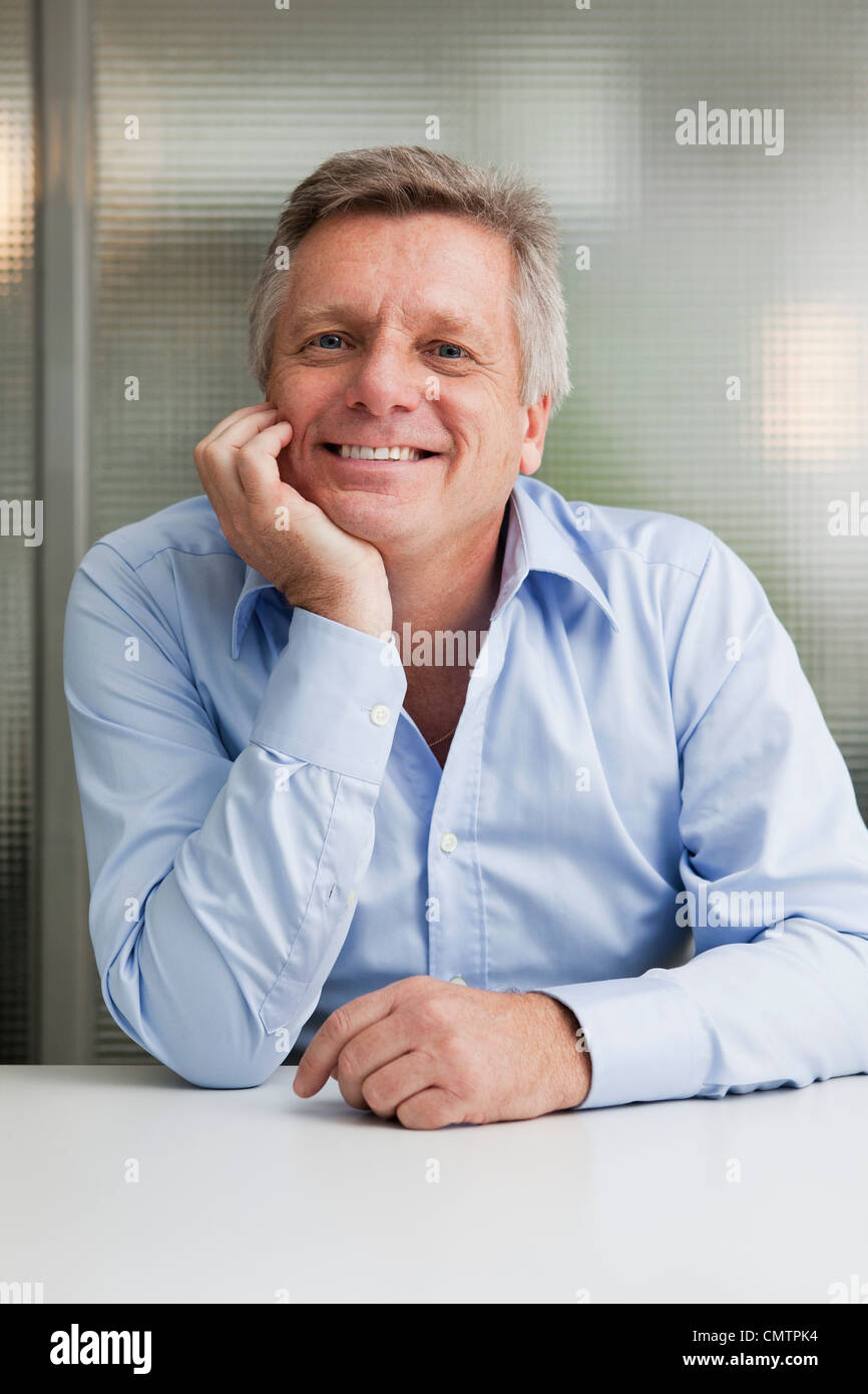 Portrait of businessman looking at camera Stock Photo - Alamy