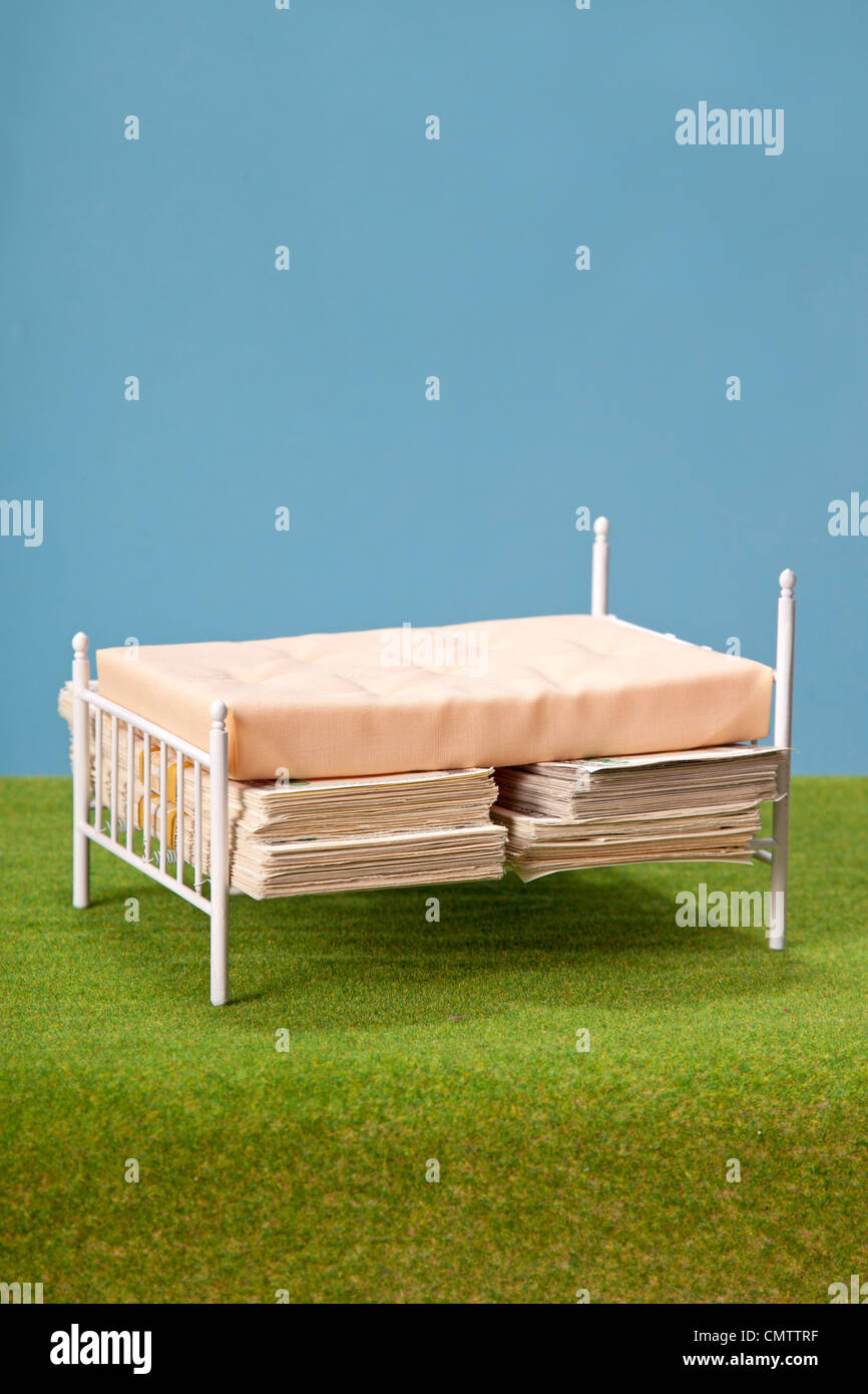 bed with money hidden under mattress Stock Photo