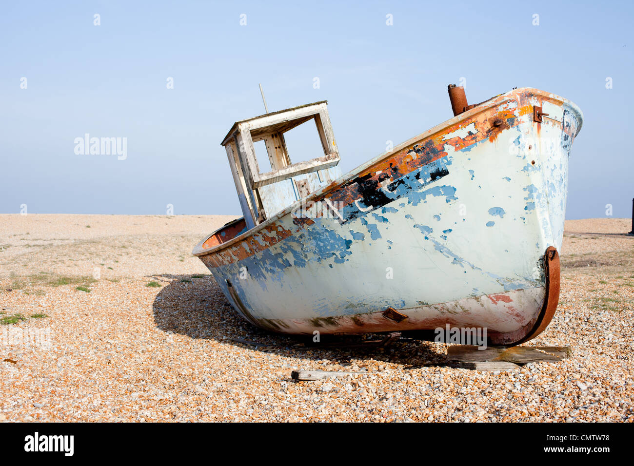 Old fishing boat left abandoned on the beach at Dungeness in Kent, UK ...