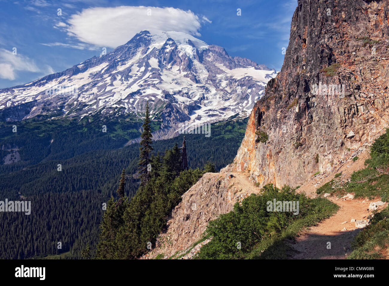 Spectacular view of Washington’s Mount Rainier  with lenticular cloud above Paradise Valley from the trail up to Plummer Peak. Stock Photo