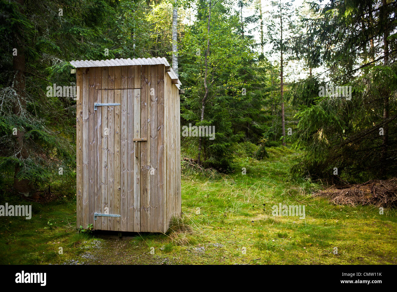 Outhouse in the woods Stock Photo