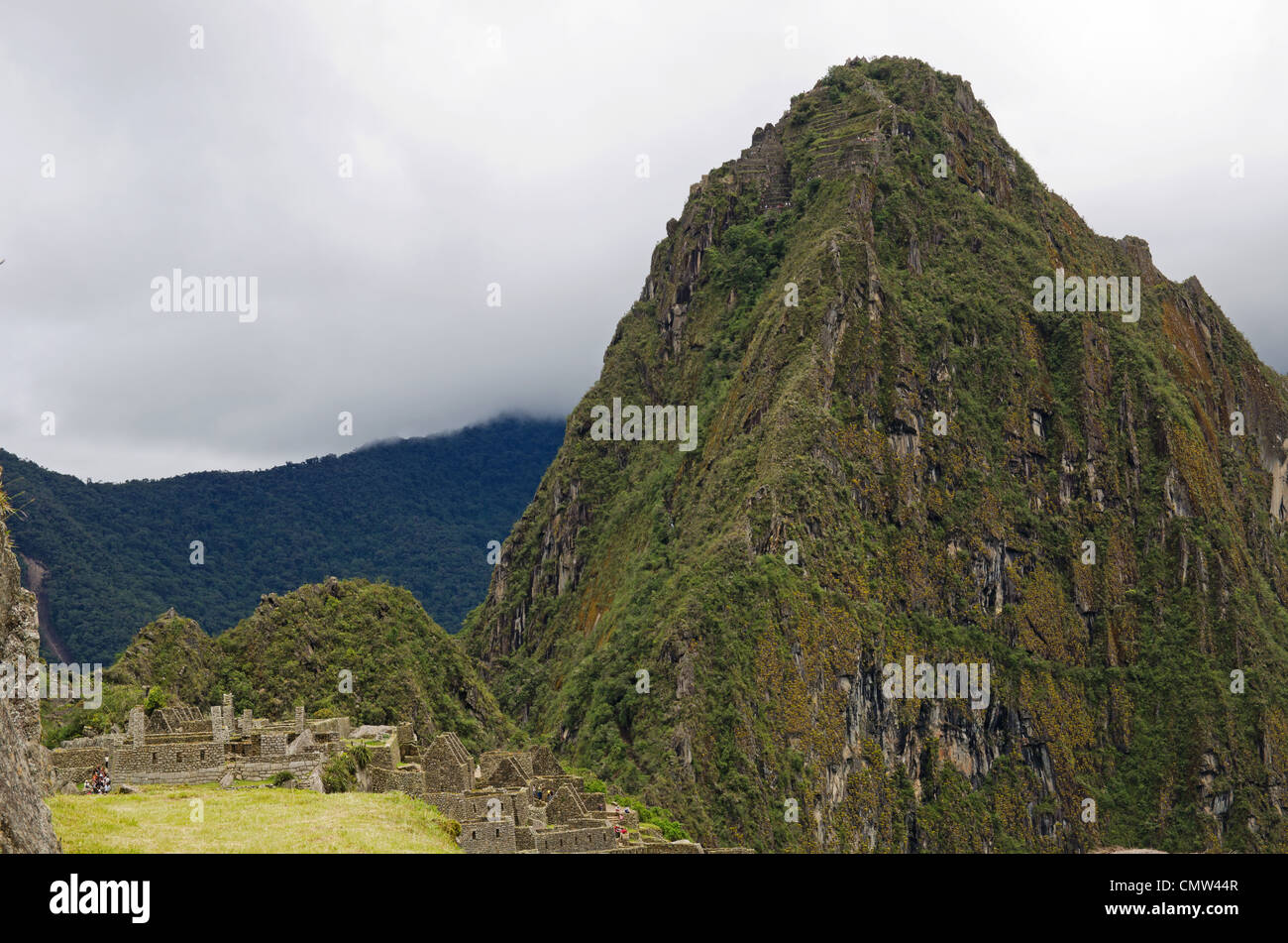 The mountain Huayna Picchu, or Wayna Picchu, which means Young Peak in Quechua, rises over the ruins of Machu Picchu, Peru Stock Photo