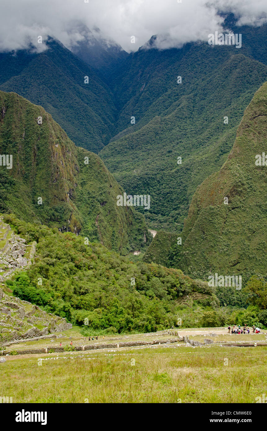 Looking down over the Inca terraces at Machu Picchu into the Urubamba gorge towards the township of Agua Calientes Stock Photo