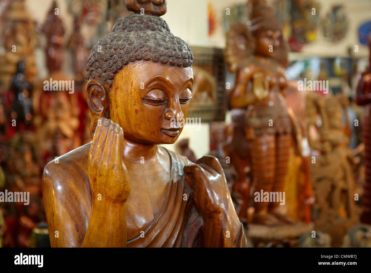 Sri Lanka - traditional wood carving, shop with wooden souvenirs, detail of buddha statue Stock Photo