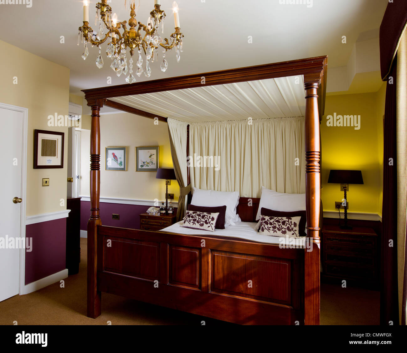 four poster bed in hotel room bedroom Stock Photo