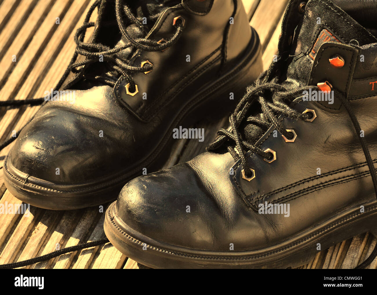 A pair of old black boots in sepia tones Stock Photo