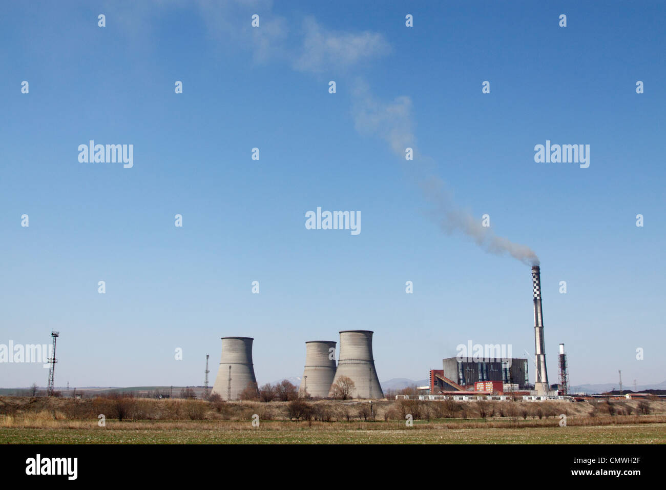 Coal-fired, thermo-electric power plant Bobov Dol in western Bulgaria, chimney spewing black smoke into deep-blue sky Stock Photo