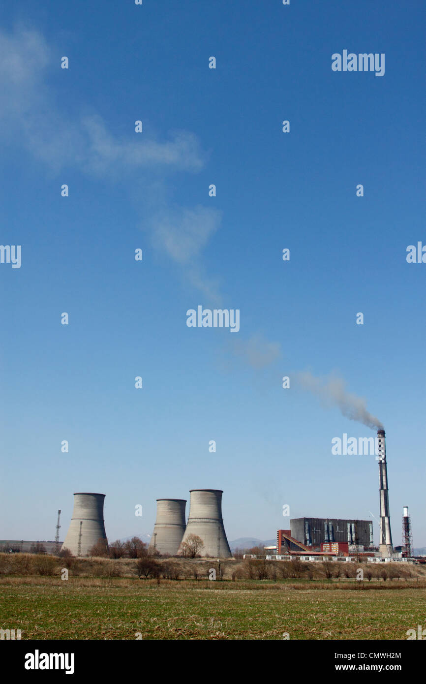 Coal-fired, thermo-electric power plant Bobov Dol in western Bulgaria, chimney spewing black smoke into deep-blue sky Stock Photo