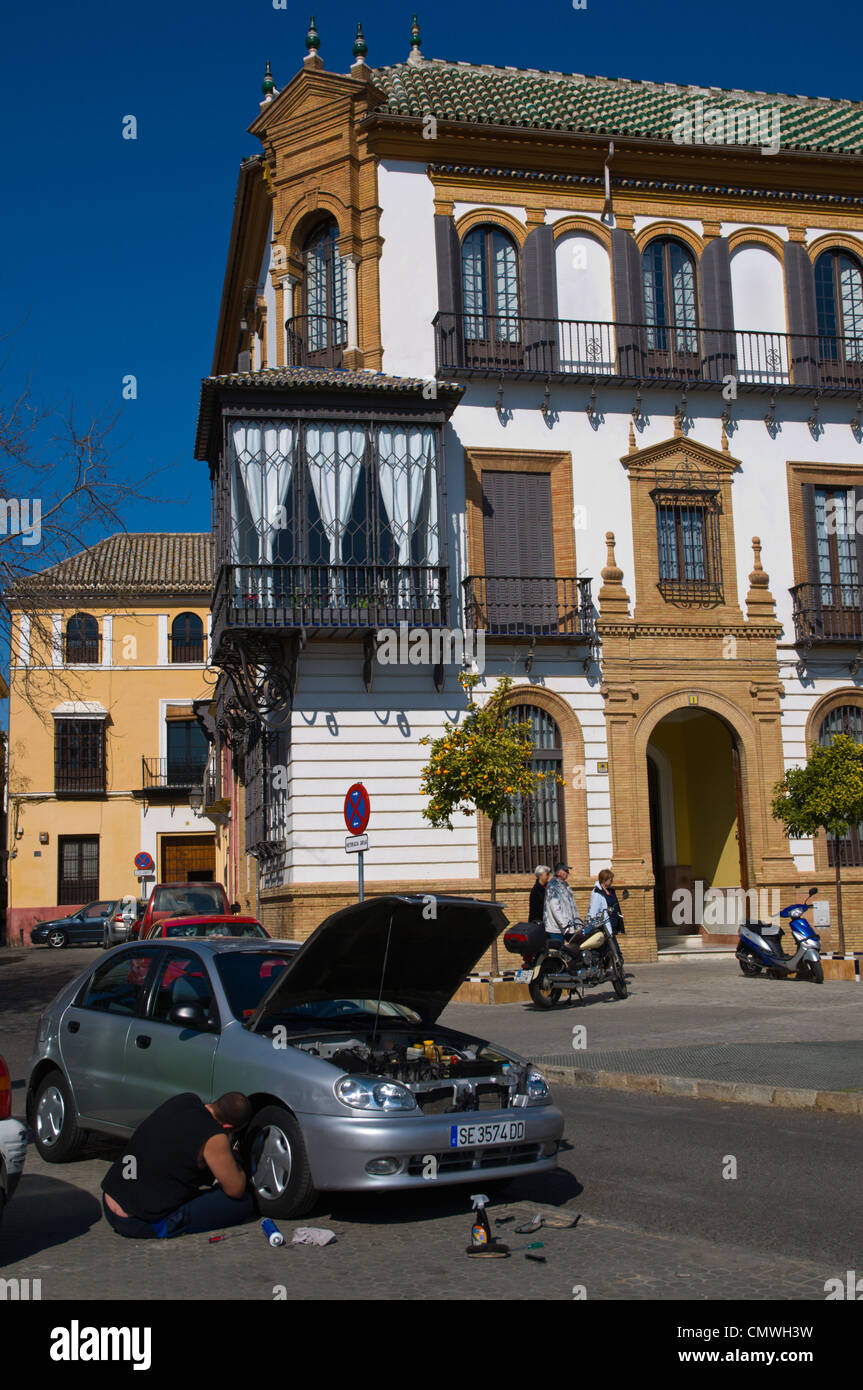 Man working on his car Plaza de los Refinadores square Santa Cruz district central Seville Andalusia Spain Stock Photo