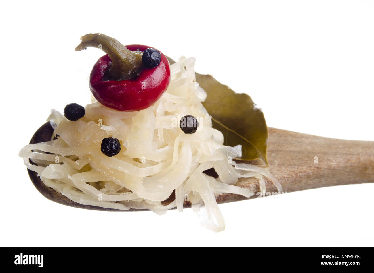 Sauerkraut and bay leaf on a wooden spoon Stock Photo