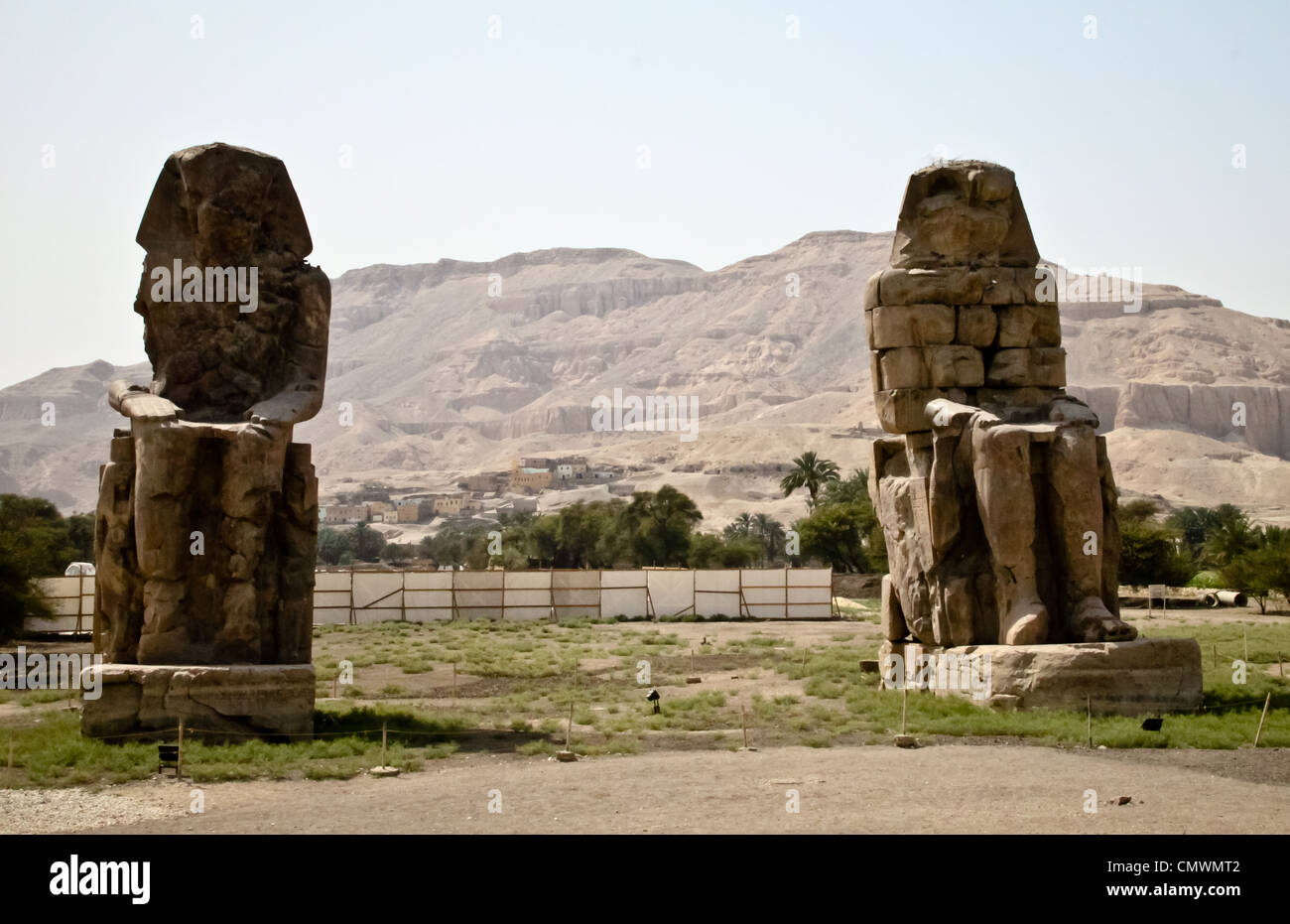 The giants of Memnon sites near the sacred temple of Luxor in Egypt Stock Photo