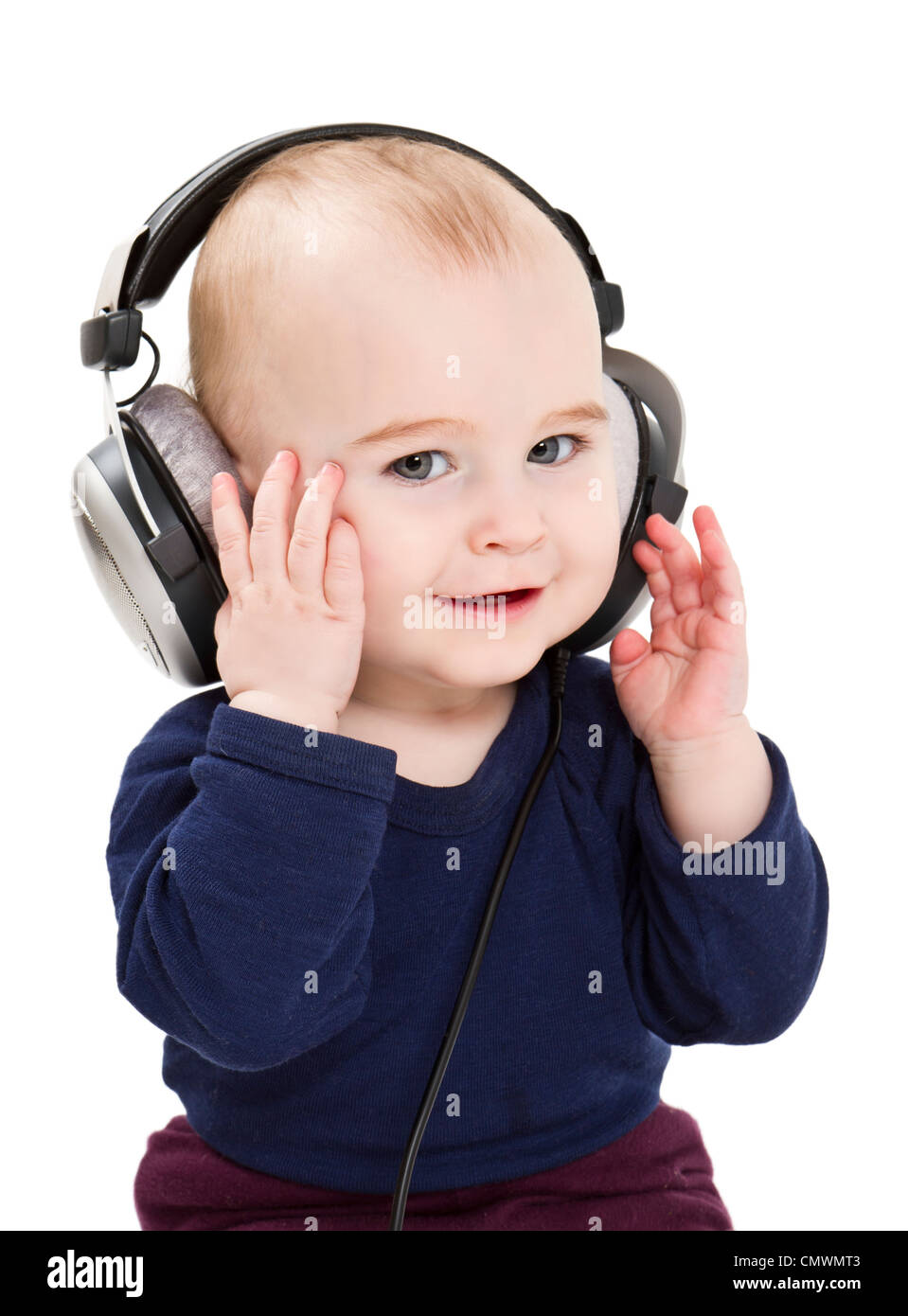 young child with earphones listening to music. isolated on white