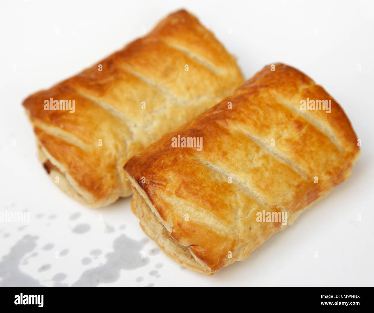 hot sausage rolls wrapped in paper with grease fat leaking out Stock Photo