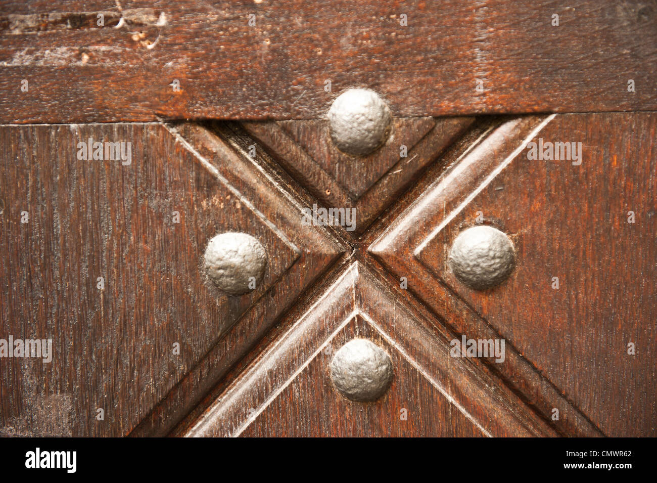 Four dots between a criss-cross door design. Stock Photo