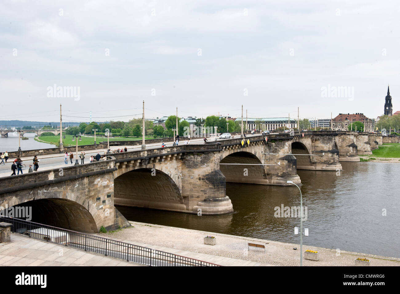 A cool daytime shot of Dresden Bridge as tourists and citizens walk to