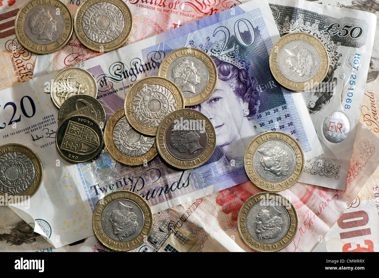 Bank notes and coins of different denominations. British Sterling currency. Stock Photo