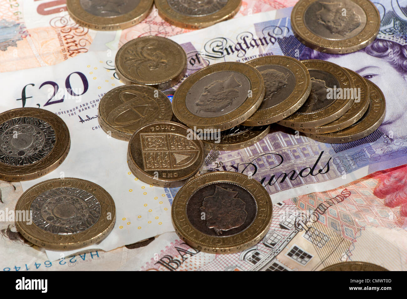 Bank notes and coins of different denominations. British Sterling currency. Stock Photo