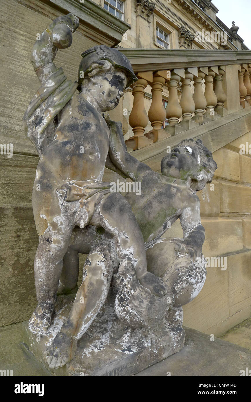 A sculpture of two cherubs fighting near the terrace of Harewood House Stock Photo