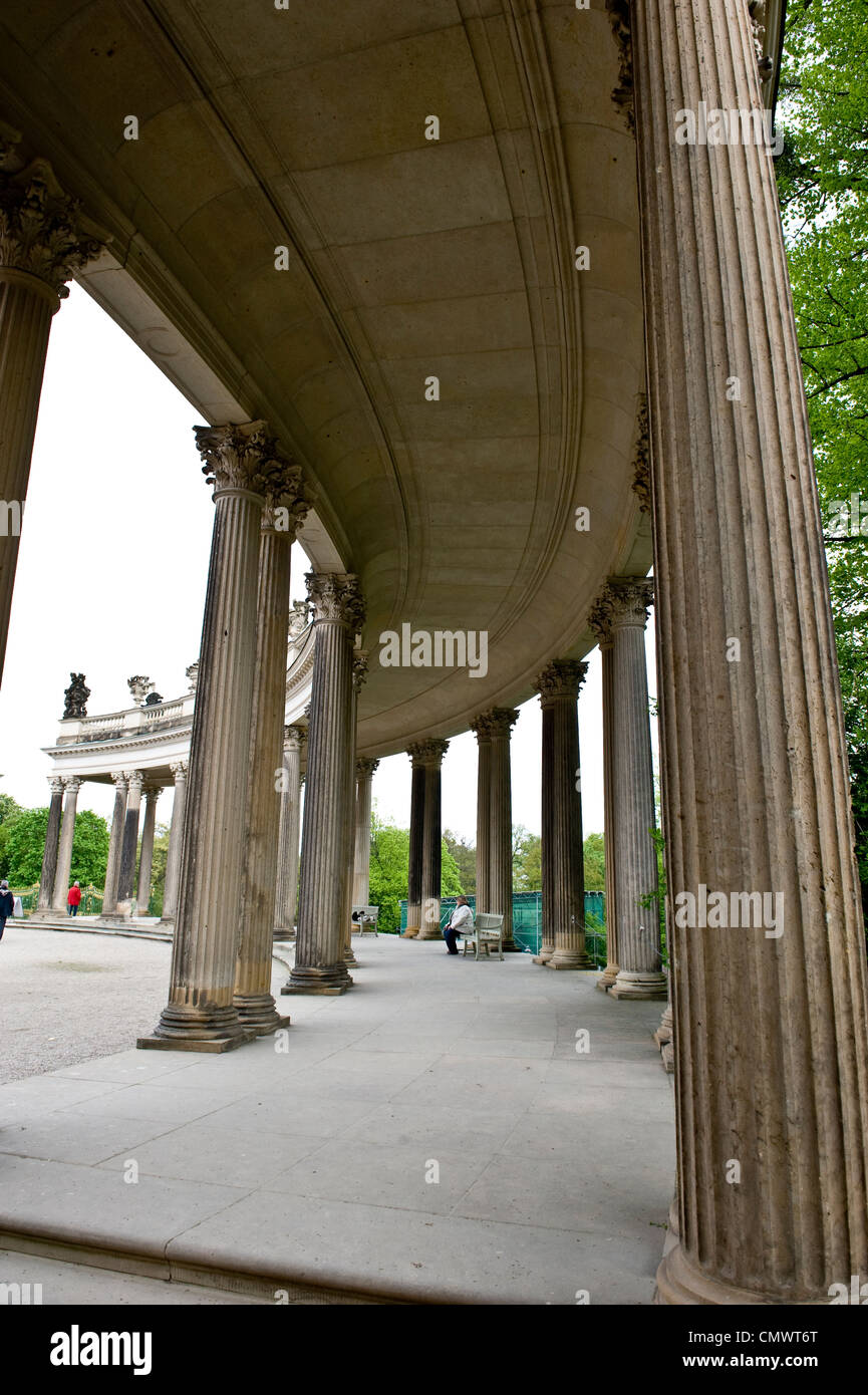 A concave, Greek column path surrounded by trees. Stock Photo