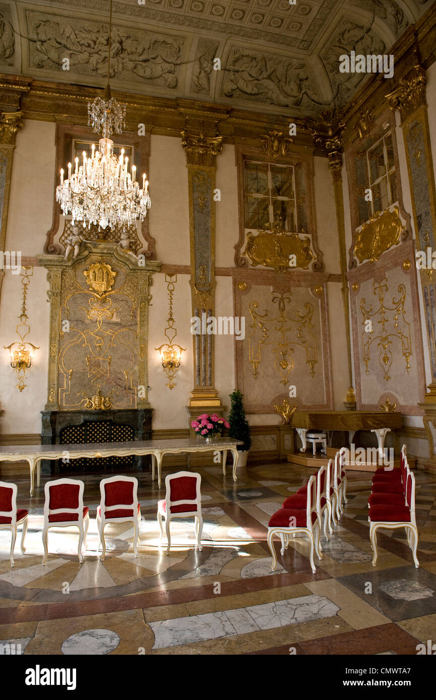 An aureate, historical ballroom filled with red chairs. Stock Photo