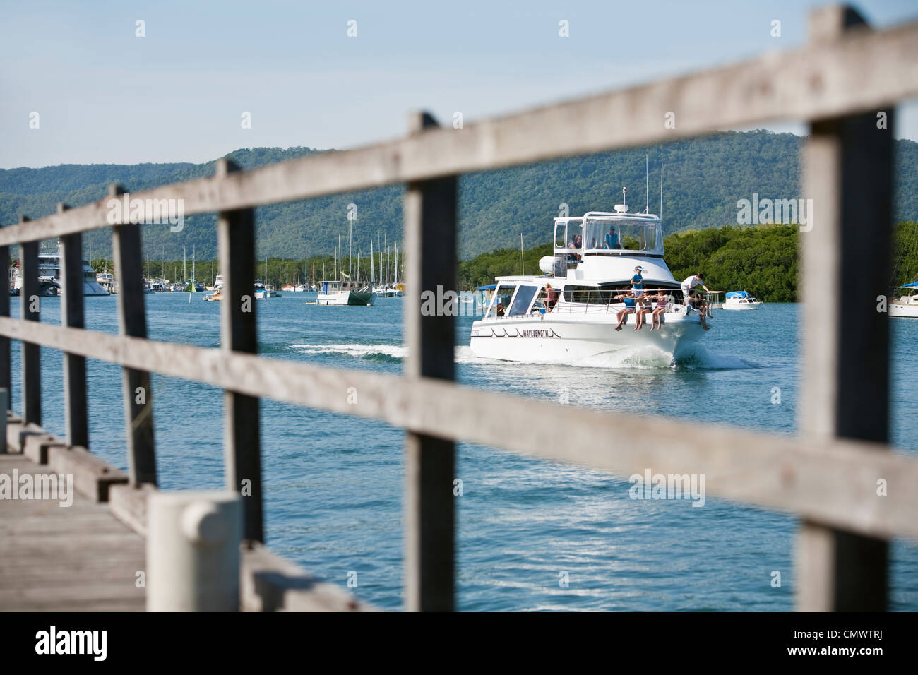 A dive boat heads out to sea viewed from Sugar Wharf. Port Douglas, Queensland, Australia Stock Photo