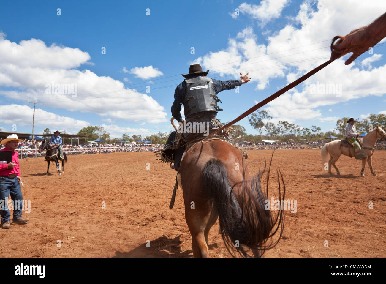 Saddle bronc rider in action at Mt Garnet Rodeo. Mt Garnet, Queensland, Australia Stock Photo