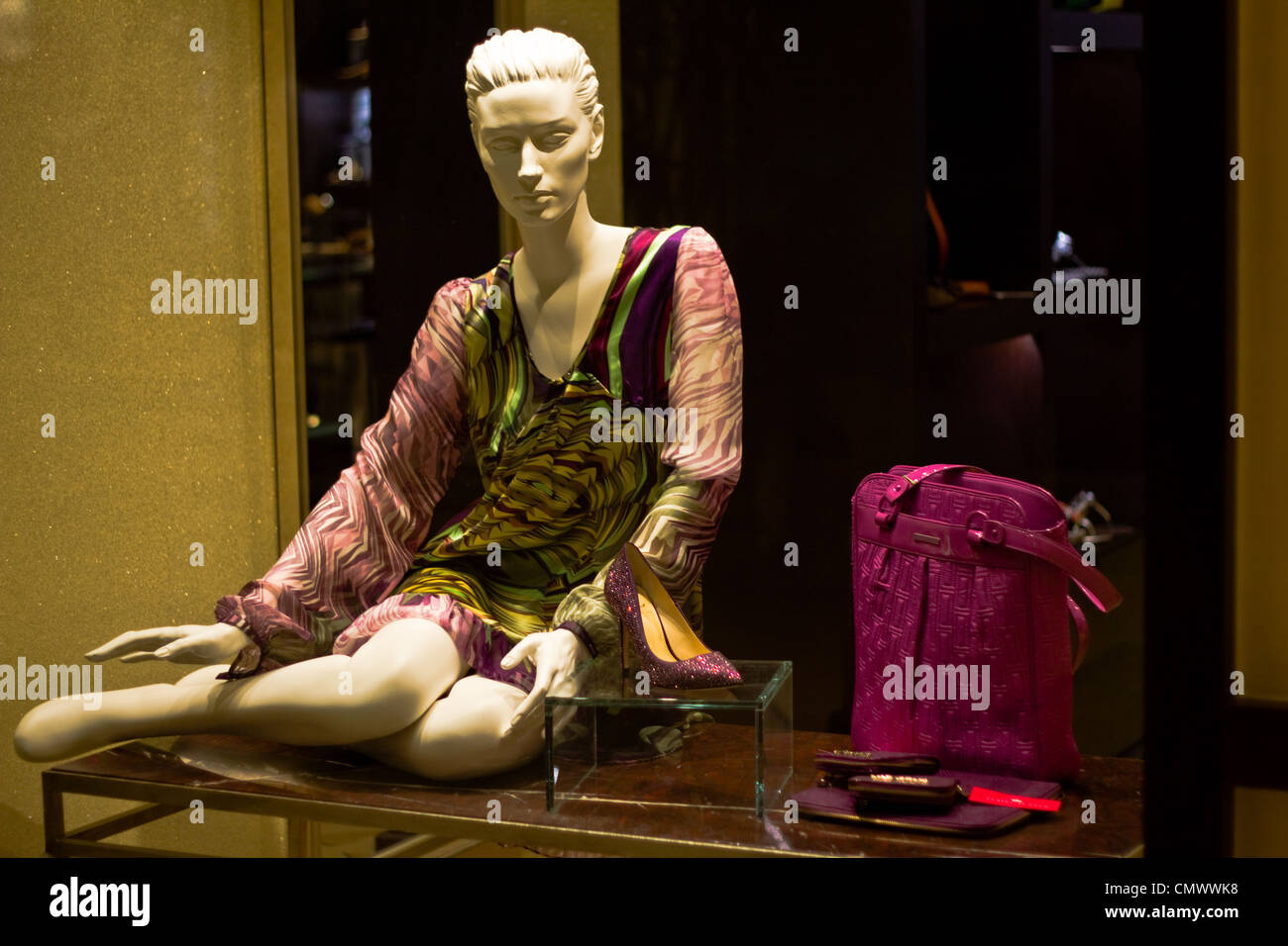 A white mannequin shows the latest fashions in a window display Stock