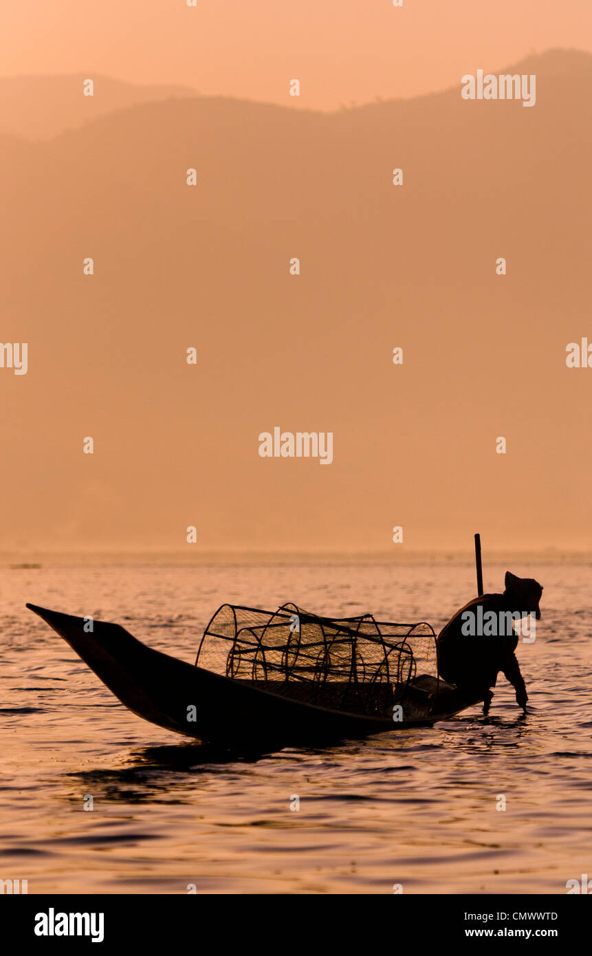 Silhouette of traditional bamboo fisherman and his boat, Inle lake ...
