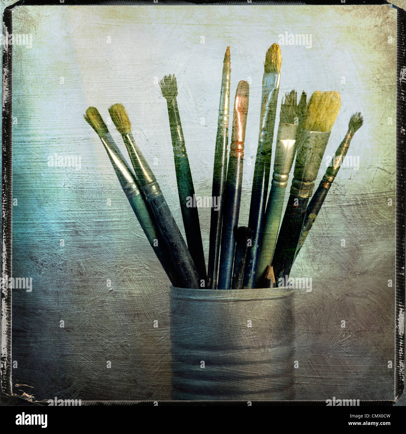 Paintbrushes in a tin, vintage look still life. Stock Photo