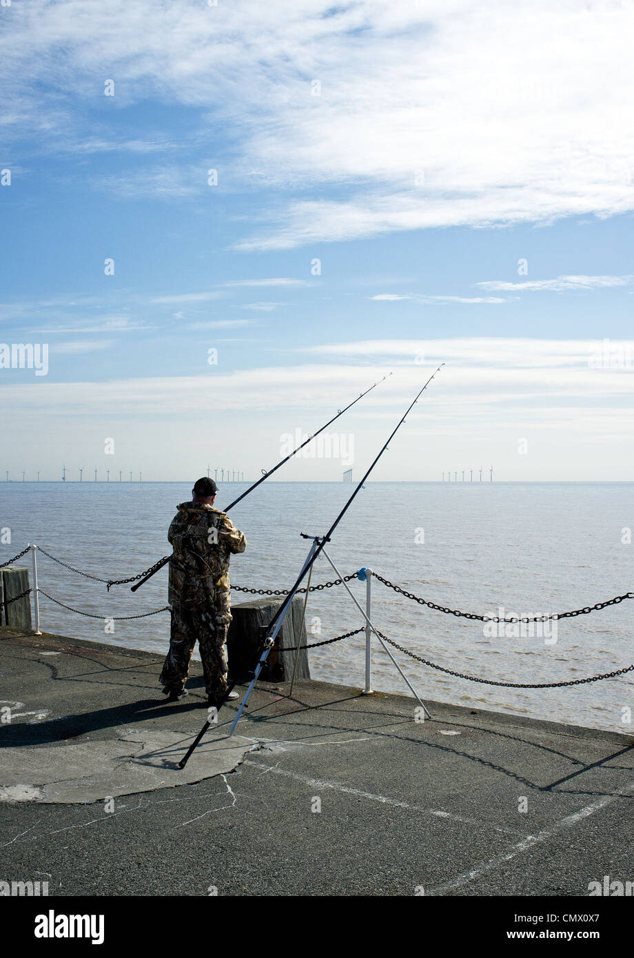 An angler fishing on Clacton Pier Stock Photo