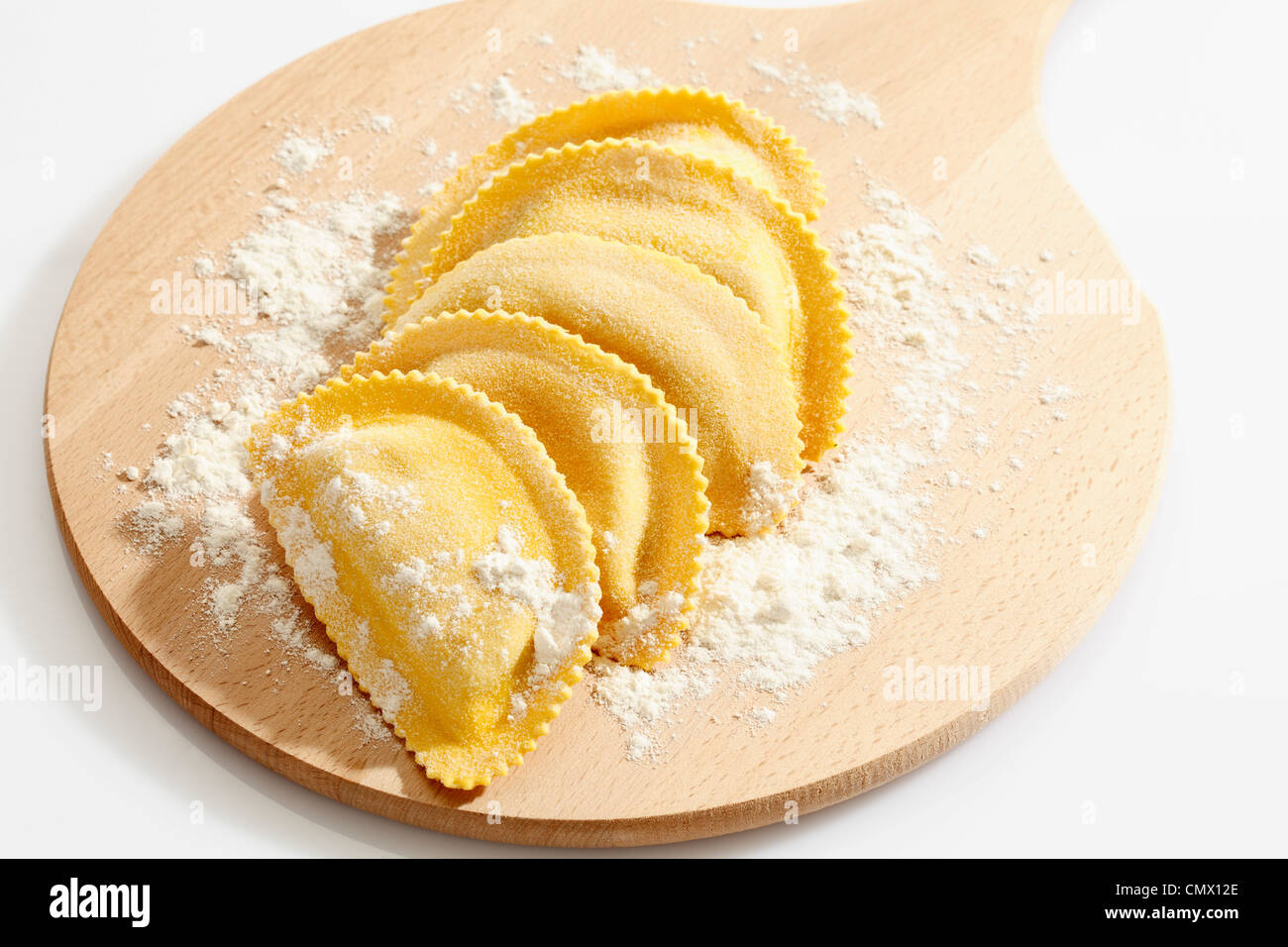Crescent shape pasta with flour on chopping board Stock Photo Alamy