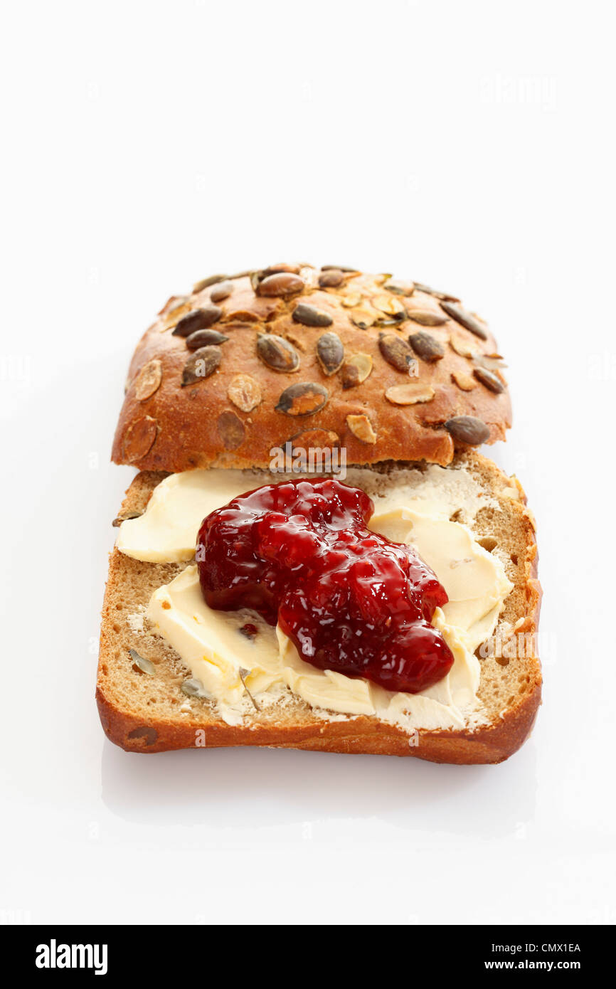 Wholemeal bread with butter and jam on white background Stock Photo Alamy