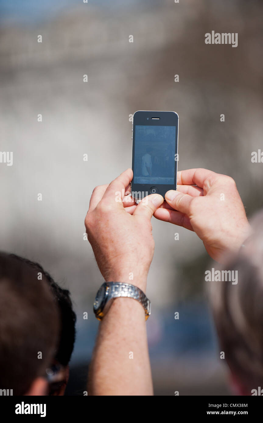 A man using an iPhone to record an event Stock Photo Alamy