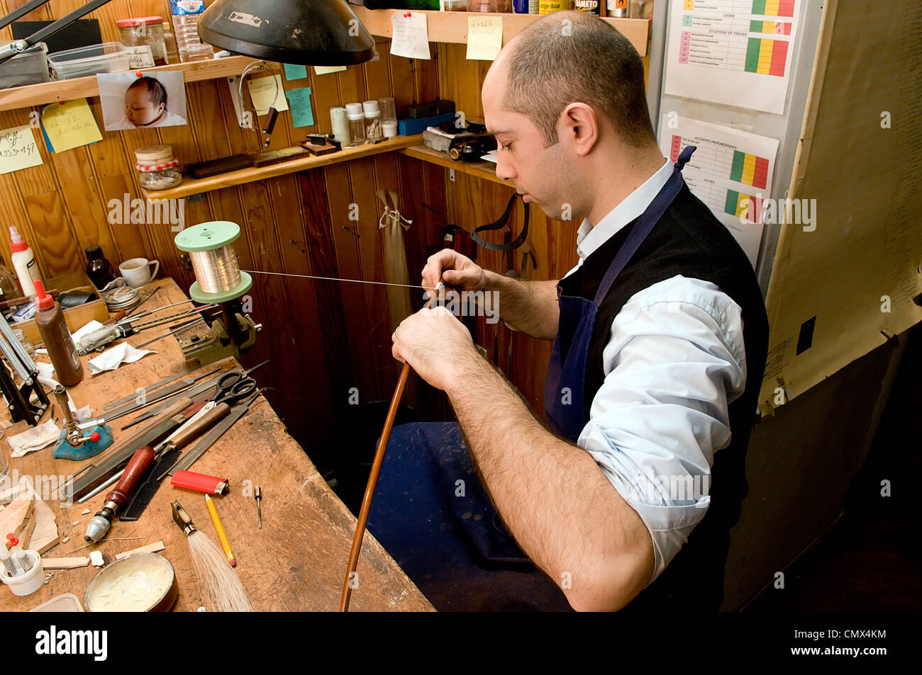 Putting the lapping on the bow, Raffin Workshop Bowmakers, Paris Stock Photo