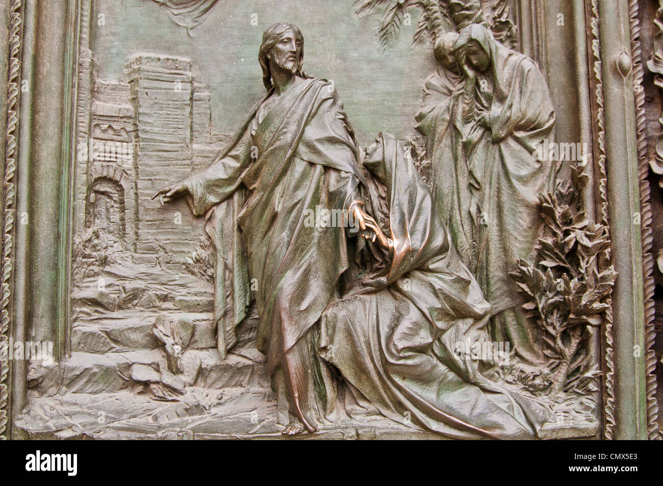 A detail of one of the bronze doors to the Duomo in Milan Stock Photo