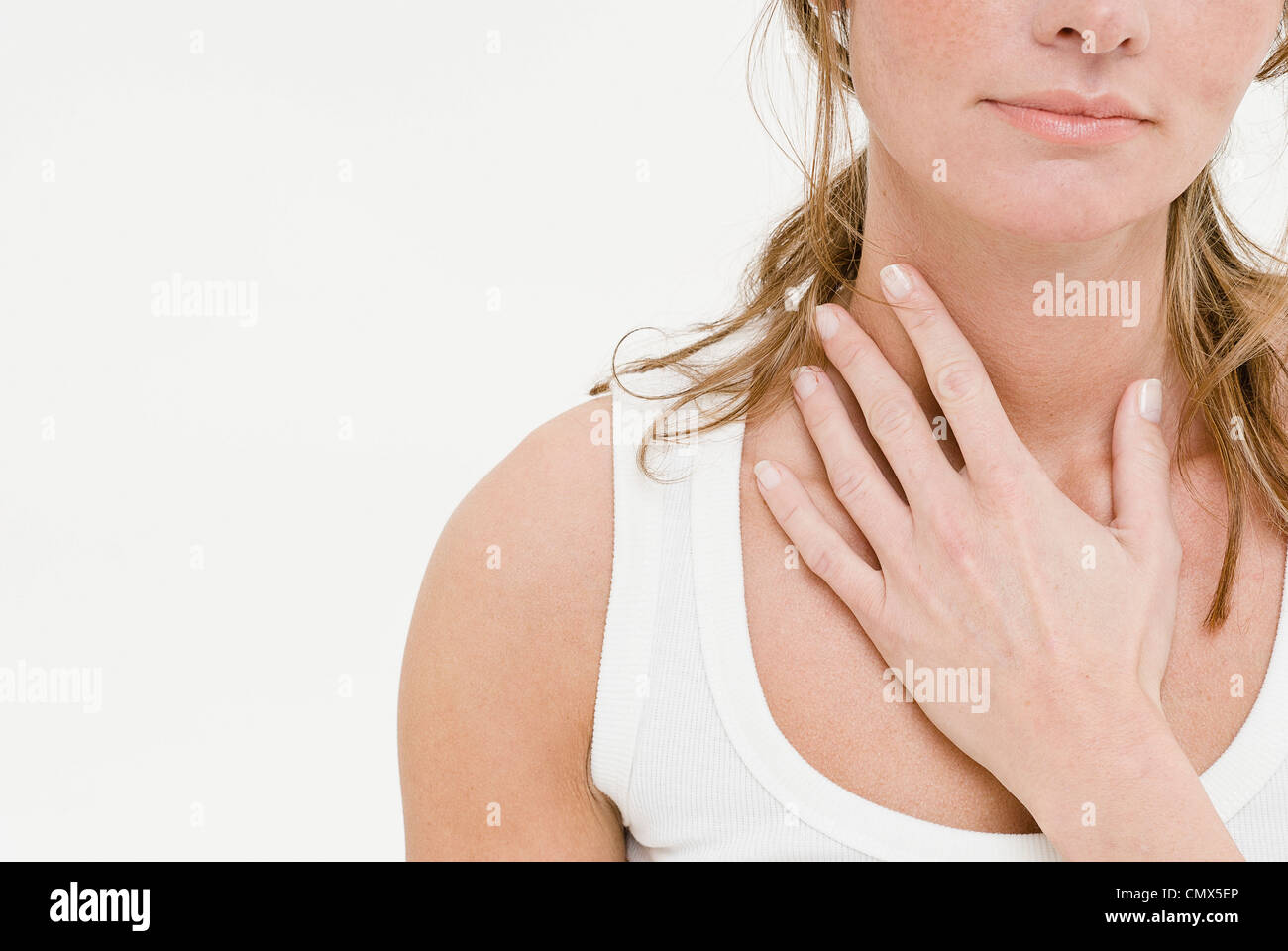 Young woman touching neck, close up Stock Photo