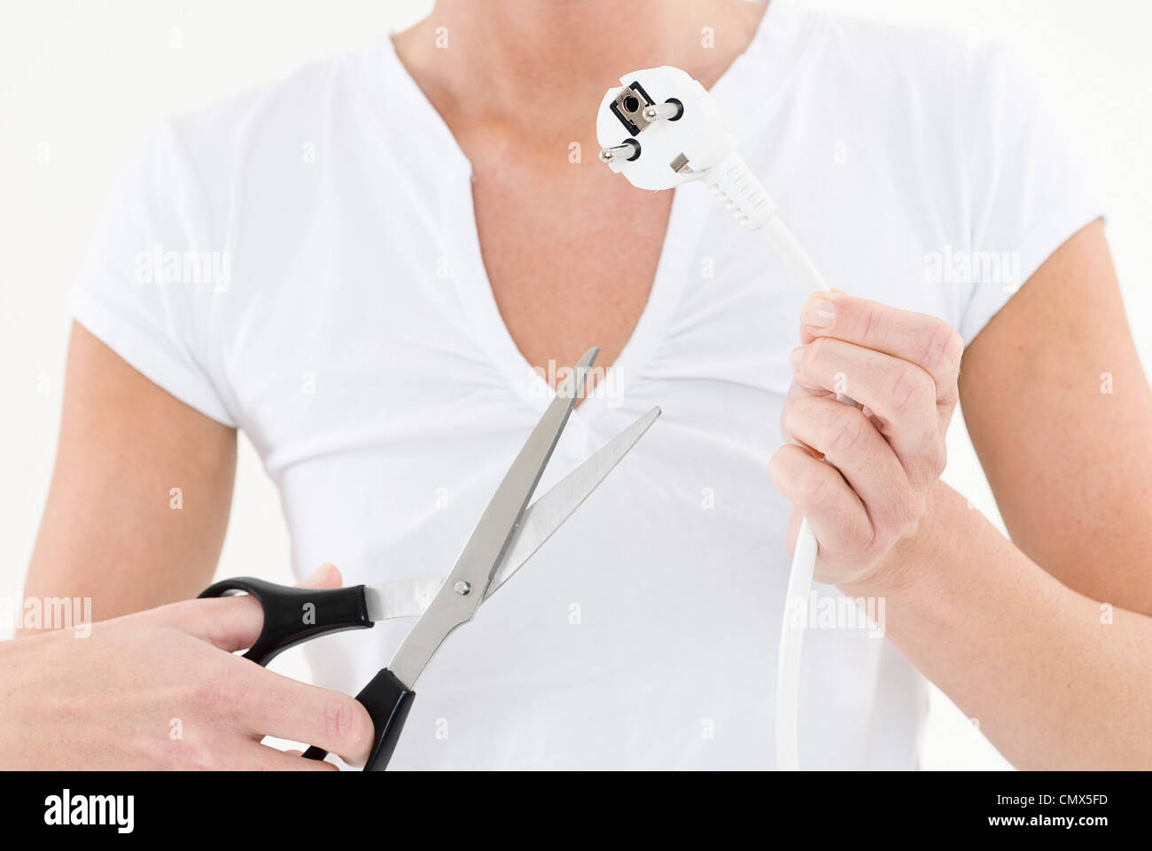 Young woman cutting electric power cord, close up Stock Photo Alamy