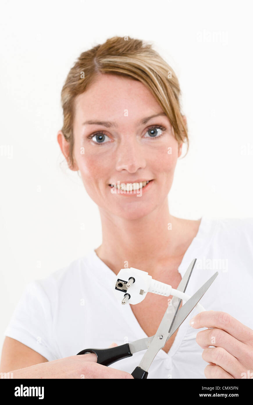 Young woman cutting electric power cord, portrait Stock Photo Alamy