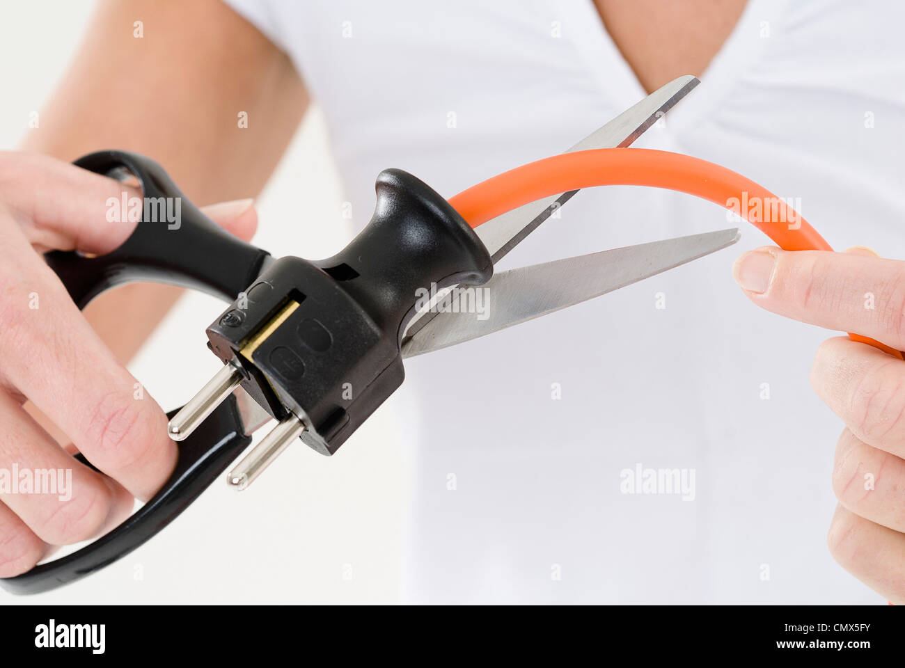 Young woman cutting electric power cord, close up Stock Photo Alamy