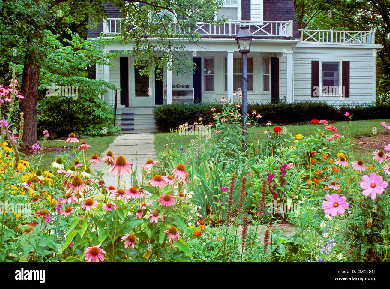 White clapboard house with cottage garden leading to front porch, Maine USA Stock Photo